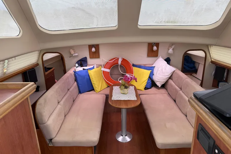 Sirenia Yacht Photos Pics Interior of 2014 Gemini Legacy 35 sailboat with cozy seating and colorful cushions.