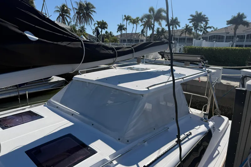 Sirenia Yacht Photos Pics 2014 Gemini Legacy 35 catamaran docked, featuring sleek design and tropical palm tree backdrop.