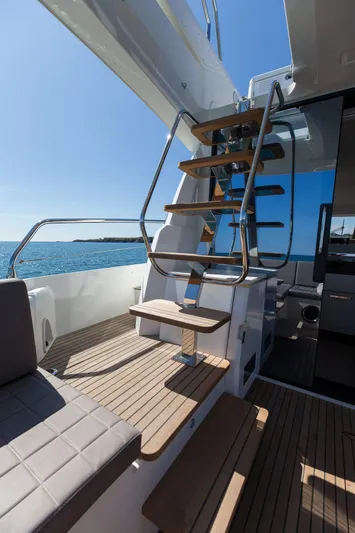 Aura Yacht Photos Pics Prestige 520 yacht, 2018 model, featuring elegant wooden stairs and ocean view.