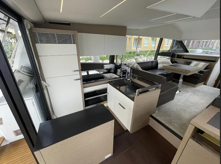 Aura Yacht Photos Pics Luxurious interior of a 2018 Prestige 520 yacht with modern kitchen and seating area.
