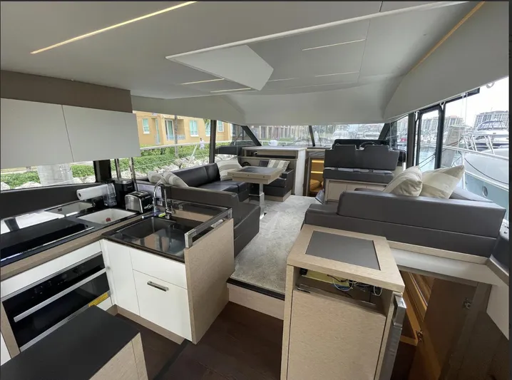 Aura Yacht Photos Pics Luxurious interior of a 2018 Prestige 520 yacht with modern kitchen and seating area.