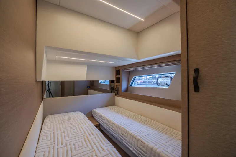 Aura Yacht Photos Pics Interior of 2018 Prestige 520 yacht with twin beds and window view.