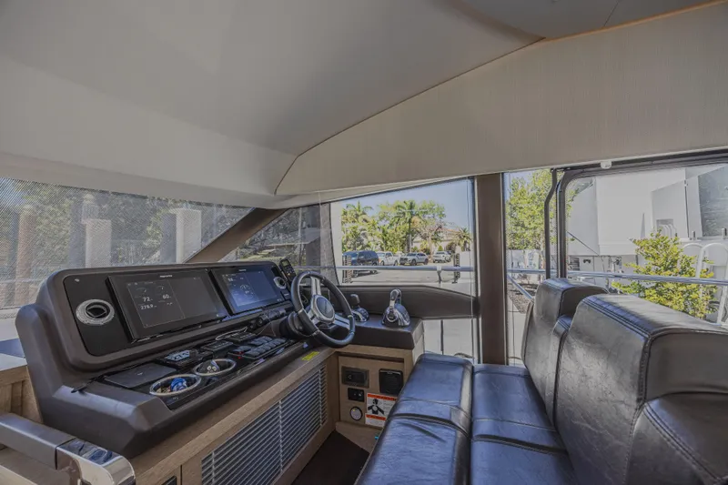 Aura Yacht Photos Pics Interior of a 2018 Prestige 520 yacht, featuring a modern helm and seating area.