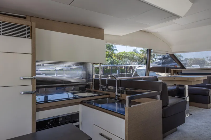 Aura Yacht Photos Pics Luxurious interior of a 2018 Prestige 520 yacht with modern kitchen and seating area.