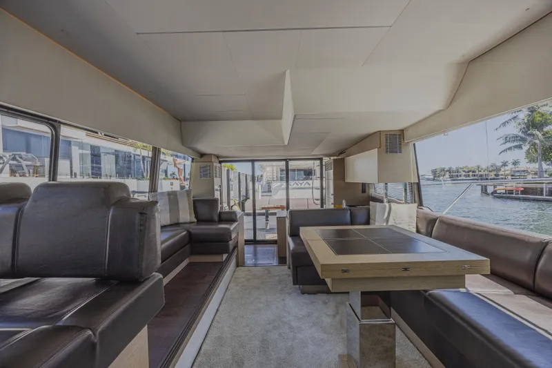 Aura Yacht Photos Pics Luxurious interior of 2018 Prestige 520 yacht with elegant seating and dining area.