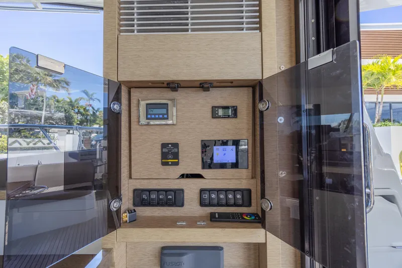Aura Yacht Photos Pics Control panel inside a 2018 Prestige 520 yacht, featuring various switches and displays.
