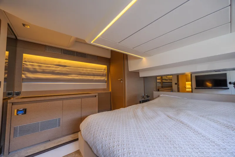 Aura Yacht Photos Pics Luxurious interior of a 2018 Prestige 520 yacht bedroom with modern lighting and elegant design.