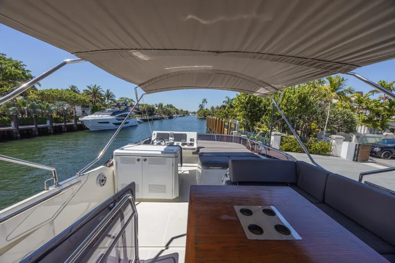 Aura Yacht Photos Pics 2018 Prestige 520 yacht interior with seating, table, and waterway view.