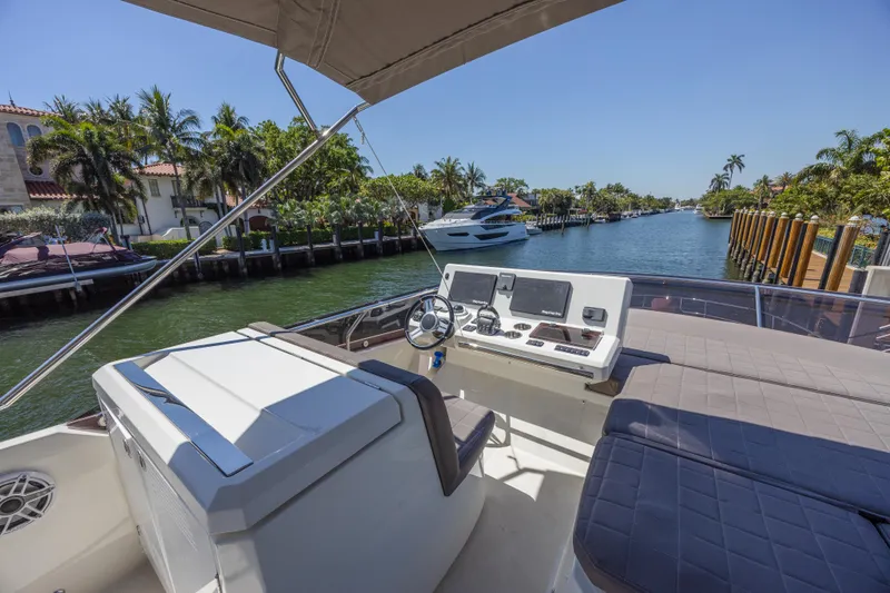 Aura Yacht Photos Pics Flybridge view of 2018 Prestige 520 yacht on a sunny canal.