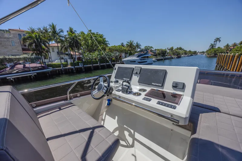 Aura Yacht Photos Pics Prestige 520 yacht helm, 2018 model, with modern navigation equipment, cruising on a sunny waterway.