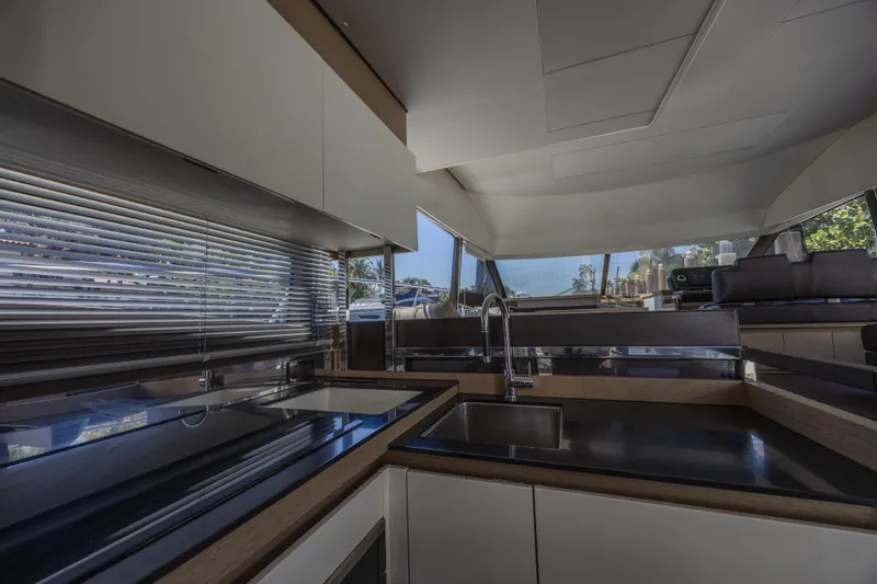 Aura Yacht Photos Pics Modern kitchen interior of 2018 Prestige 520 yacht with sleek countertops and large windows.