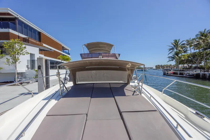 Aura Yacht Photos Pics 2018 Prestige 520 yacht docked by waterfront, featuring spacious sunbathing area.
