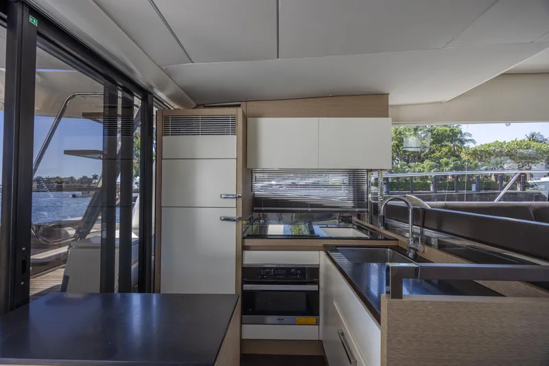 Aura Yacht Photos Pics Modern kitchen interior on 2018 Prestige 520 yacht, featuring sleek cabinetry and appliances.
