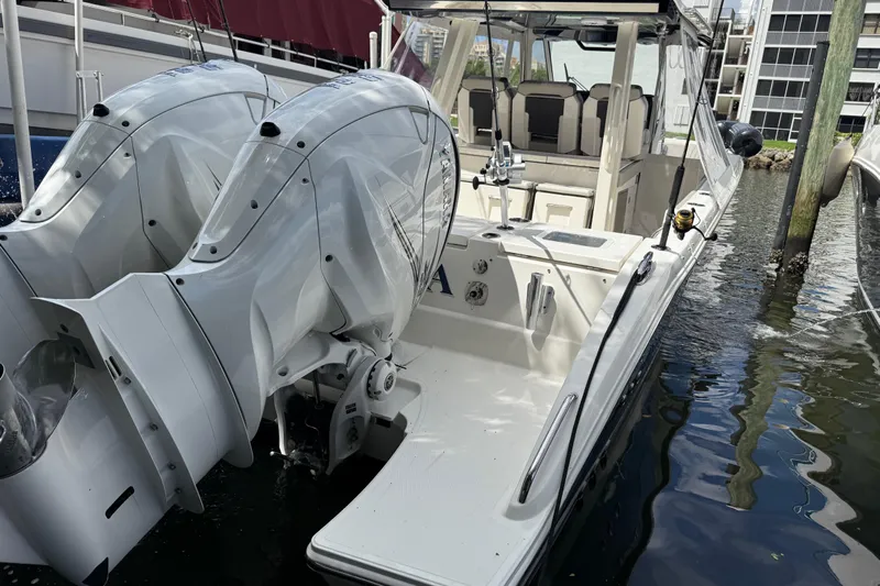  Yacht Photos Pics 2022 Pursuit S 358 Sport boat with dual outboard engines docked in marina.