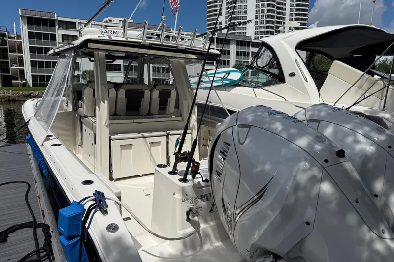  Yacht Photos Pics 2022 Pursuit S 358 Sport boat docked, featuring dual outboard engines and modern design.