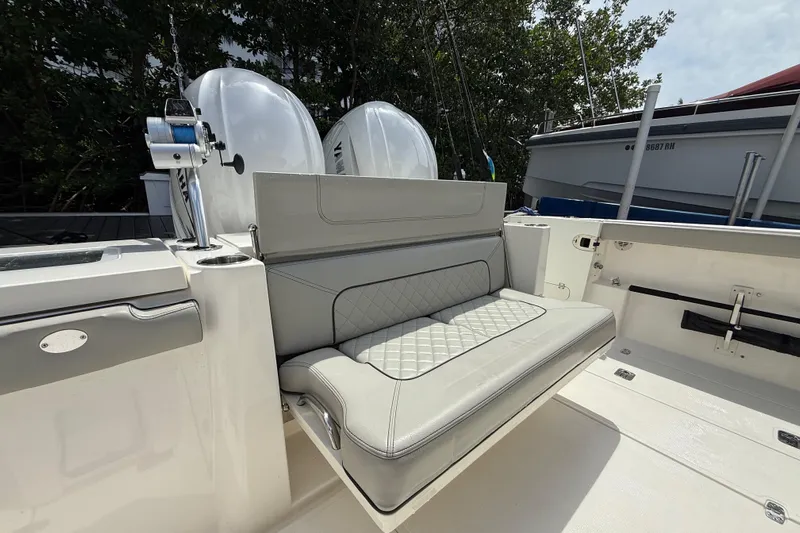  Yacht Photos Pics 2022 Pursuit S 358 Sport boat with cushioned seating and dual outboard motors.