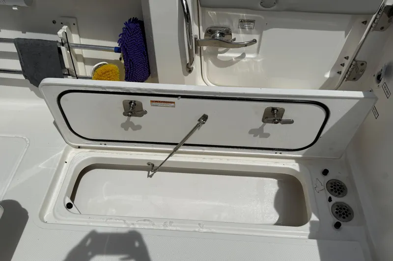  Yacht Photos Pics Open storage compartment on 2022 Pursuit S 358 Sport boat deck.