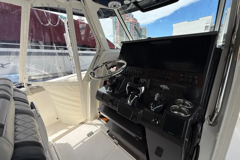  Yacht Photos Pics Interior cockpit of 2022 Pursuit S 358 Sport boat with modern controls and steering wheel.
