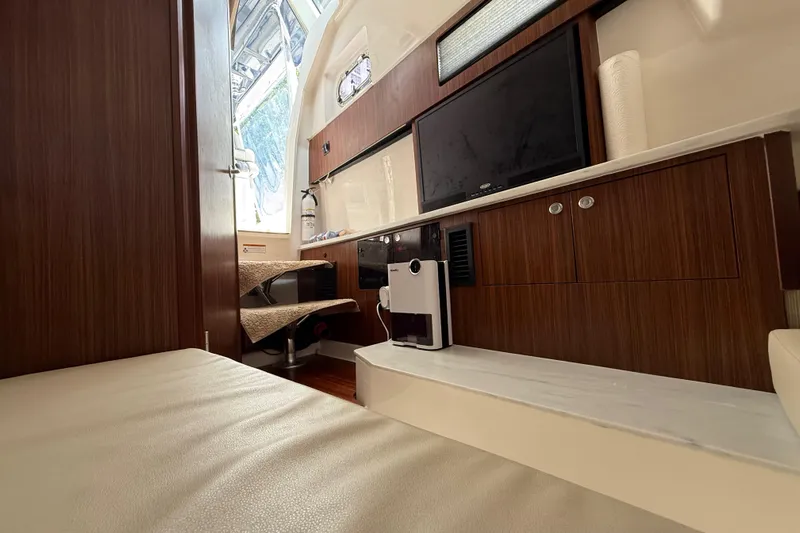  Yacht Photos Pics Interior of 2022 Pursuit S 358 Sport boat with modern wood cabinetry and seating.