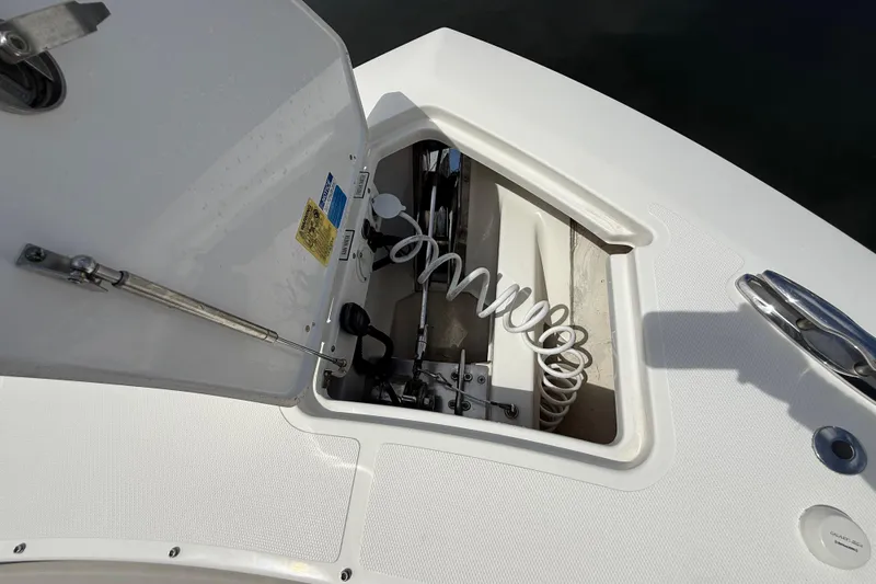  Yacht Photos Pics 2022 Pursuit S 358 Sport boat anchor compartment with open hatch and coiled rope.
