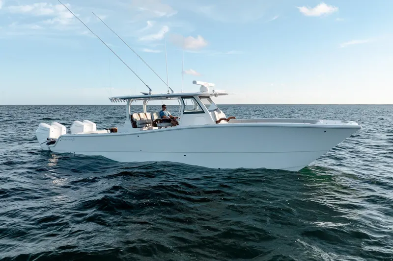  Yacht Photos Pics 2023 Freeman 43 boat on open water, featuring sleek design and multiple outboard engines.