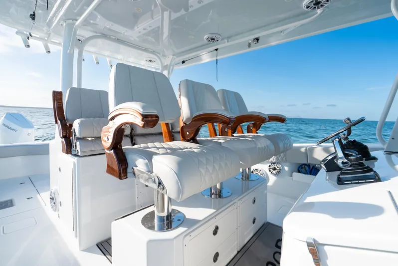  Yacht Photos Pics Luxurious seating on a 2023 Freeman 43 boat, featuring elegant wood accents and ocean backdrop.