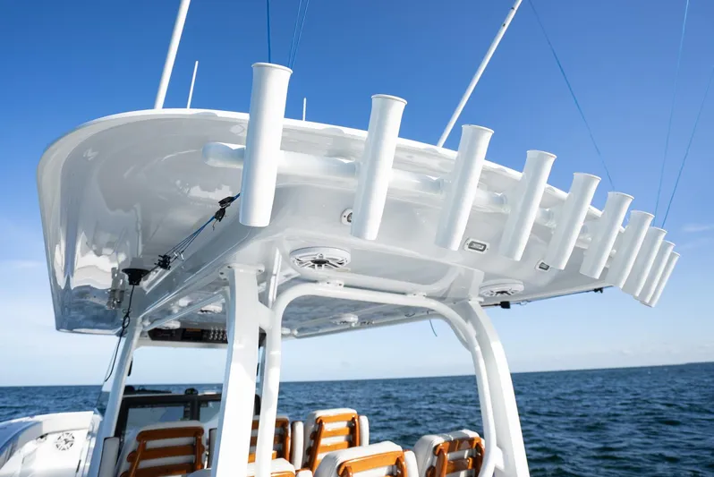  Yacht Photos Pics 2023 Freeman 43 boat with rod holders, ocean backdrop, clear blue sky.