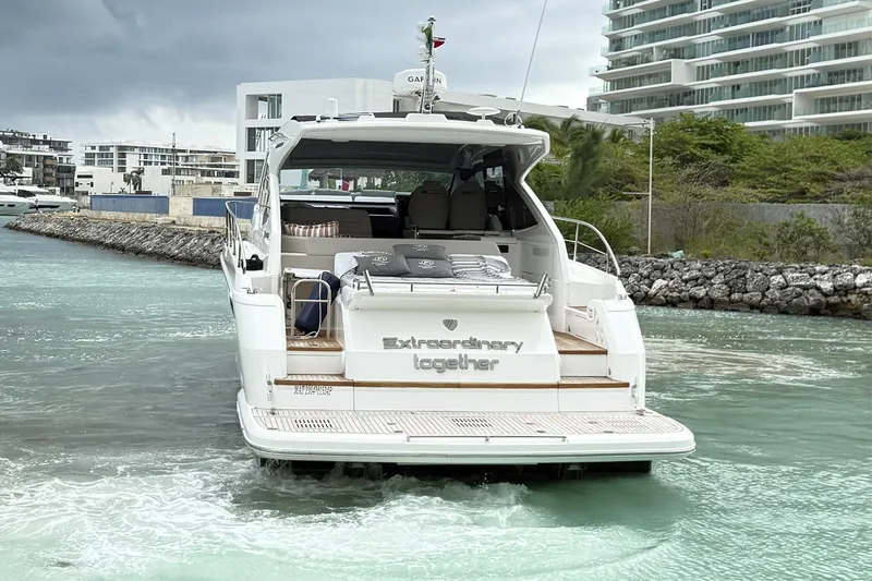 2024 Fairline Targa 50 Open @ Cancun Yacht Photos Pics 2024 Fairline Targa 50 Open yacht cruising in a coastal area with modern buildings.