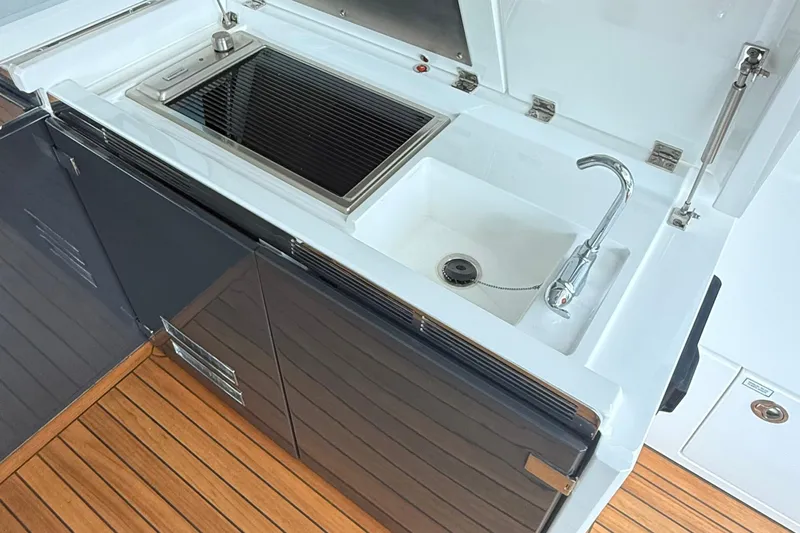 2024 Fairline Targa 50 Open @ Cancun Yacht Photos Pics 2024 Fairline Targa 50 Open yacht kitchen with sink and grill on teak flooring.