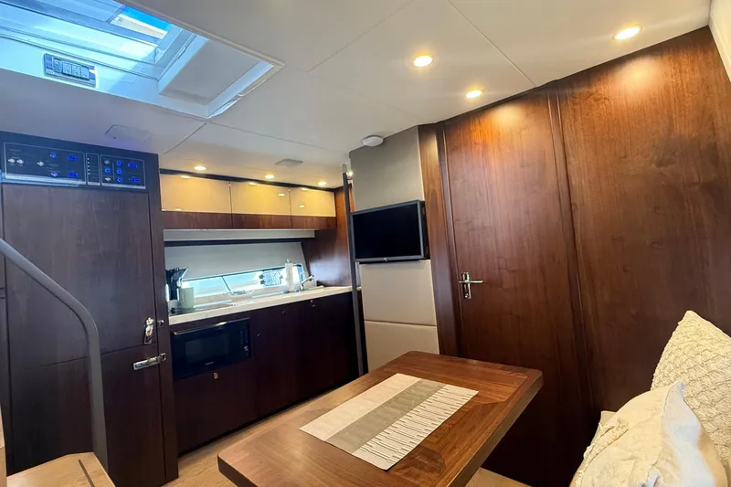 2024 Fairline Targa 50 Open @ Cancun Yacht Photos Pics Luxurious interior of 2024 Fairline Targa 50 Open yacht with modern kitchen and seating area.
