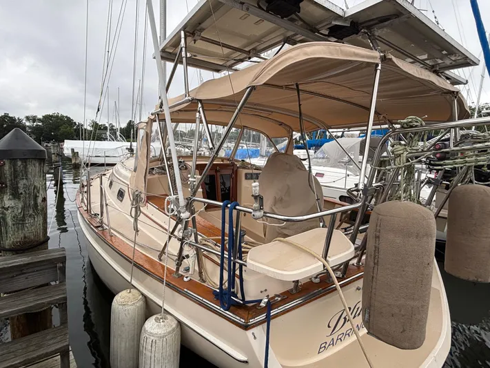 Blue Sky Yacht Photos Pics 2001 Island Packet 380 sailboat docked, featuring beige canopy and polished wood deck.