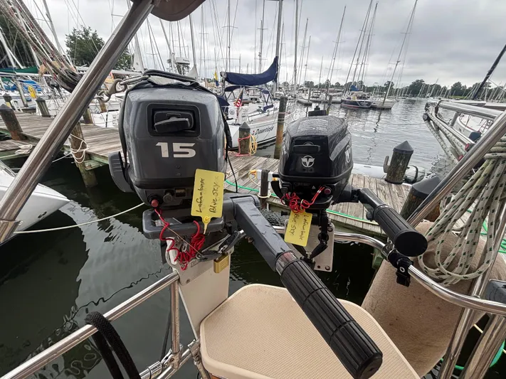 Blue Sky Yacht Photos Pics Two outboard motors on a 2001 Island Packet 380 sailboat at a marina.