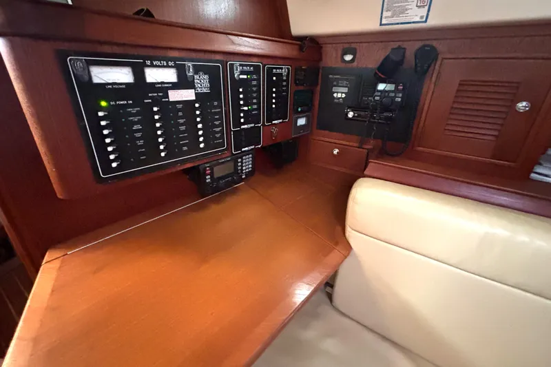Blue Sky Yacht Photos Pics Navigation station of 2001 Island Packet 380 yacht with control panels and seating.
