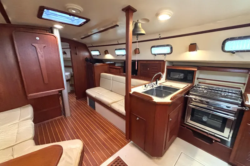 Blue Sky Yacht Photos Pics Interior of 2001 Island Packet 380 sailboat with wood finish and modern kitchen amenities.
