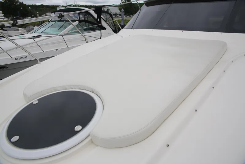  Yacht Photos Pics 2008 Silverton 38 Sport Bridge yacht with cushioned deck and circular window.