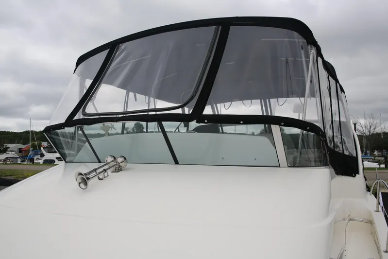  Yacht Photos Pics 2008 Silverton 38 Sport Bridge yacht with clear enclosure and dual horns.