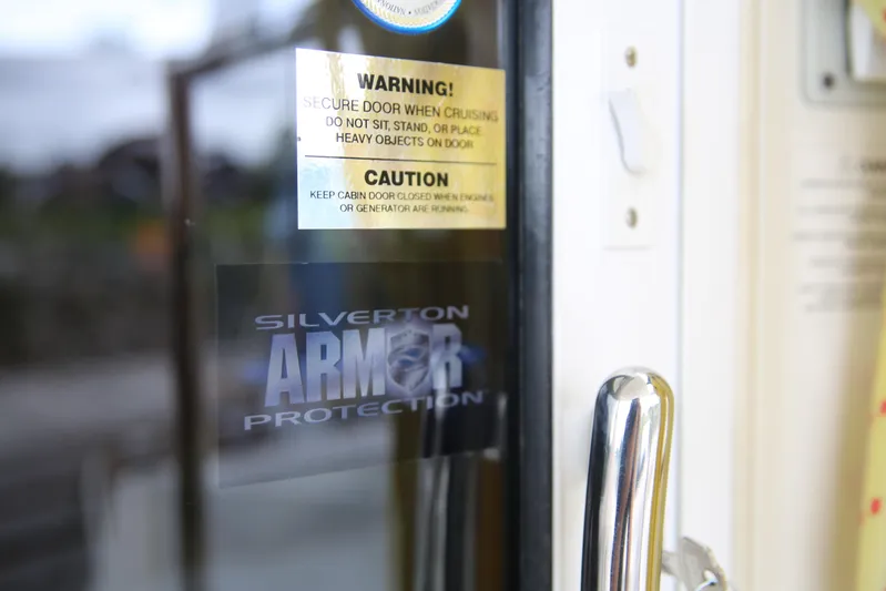  Yacht Photos Pics Close-up of a 2008 Silverton 38 Sport Bridge door with warning and caution labels.