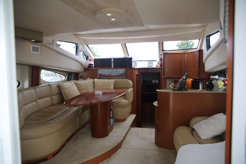  Yacht Photos Pics Luxurious interior of a 2008 Silverton 38 Sport Bridge yacht with plush seating and wooden accents.