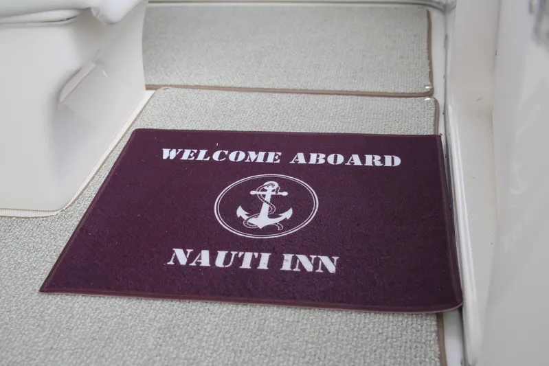  Yacht Photos Pics Welcome mat on 2008 Silverton 38 Sport Bridge, reads "Welcome Aboard Nauti Inn."