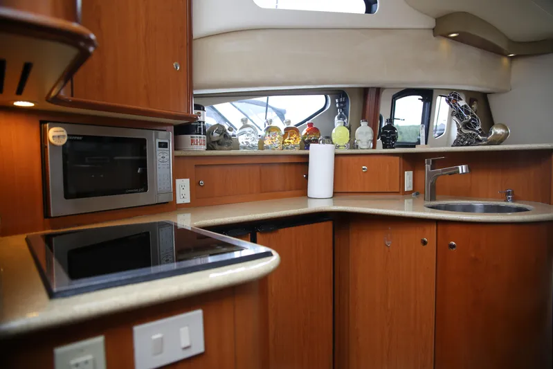  Yacht Photos Pics 2008 Silverton 38 Sport Bridge yacht kitchen with microwave, stove, and sink.