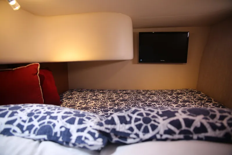  Yacht Photos Pics Cozy cabin interior of 2008 Silverton 38 Sport Bridge with patterned bedding and wall-mounted TV.