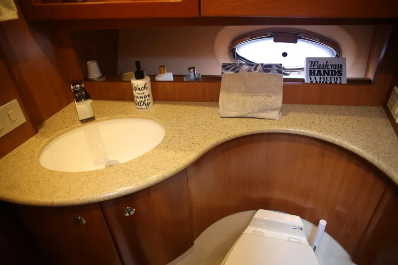  Yacht Photos Pics 2008 Silverton 38 Sport Bridge bathroom with sink, toilet, and countertop accessories.