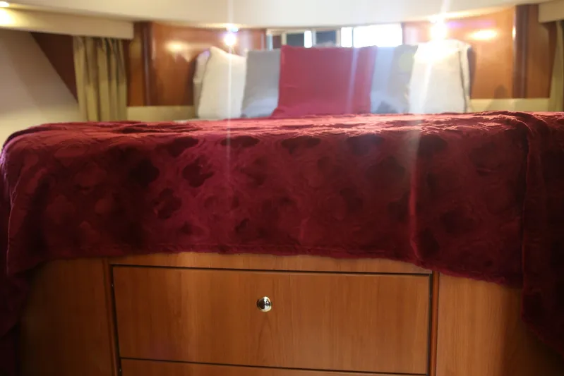  Yacht Photos Pics Luxurious bedroom interior of 2008 Silverton 38 Sport Bridge yacht with red bedding.