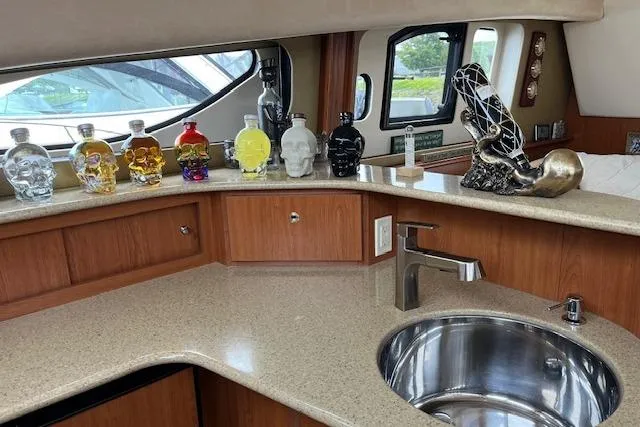  Yacht Photos Pics 2008 Silverton 38 Sport Bridge yacht interior with skull-shaped bottles on countertop.