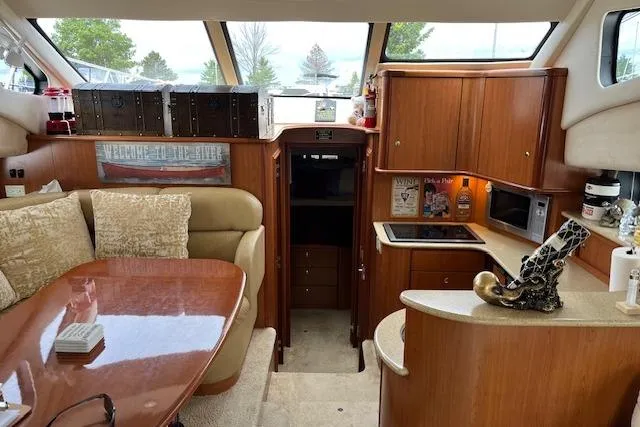  Yacht Photos Pics 2008 Silverton 38 Sport Bridge interior with dining area, kitchenette, and wood cabinetry.