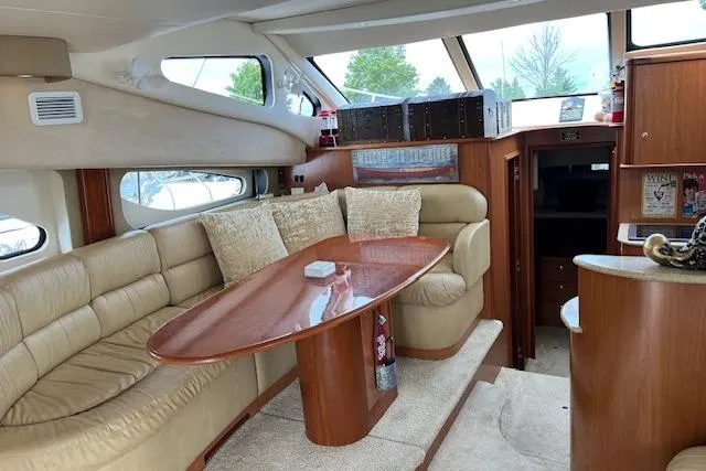  Yacht Photos Pics Interior of 2008 Silverton 38 Sport Bridge yacht with plush seating and wooden table.