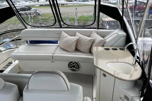  Yacht Photos Pics 2008 Silverton 38 Sport Bridge interior with seating, cushions, and compact sink area.