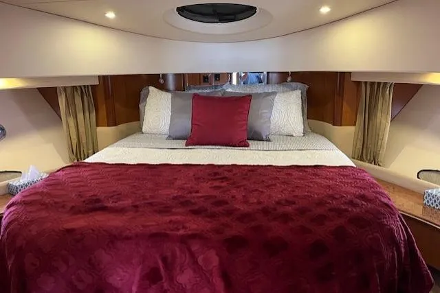 Yacht Photos Pics Luxurious bedroom interior of 2008 Silverton 38 Sport Bridge yacht with red bedding.