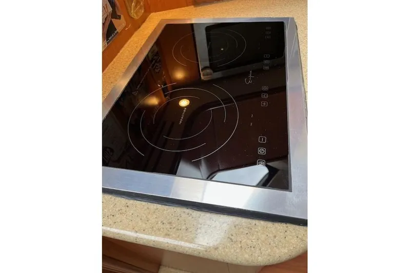  Yacht Photos Pics Modern electric cooktop on 2008 Silverton 38 Sport Bridge yacht kitchen counter.