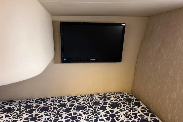  Yacht Photos Pics Interior of 2008 Silverton 38 Sport Bridge with wall-mounted TV and patterned bedding.